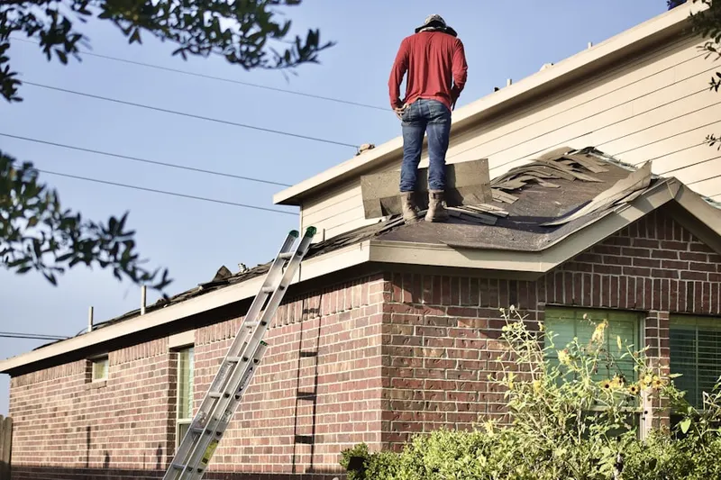 Professional roofer working on a residential roof in North Lake Worth